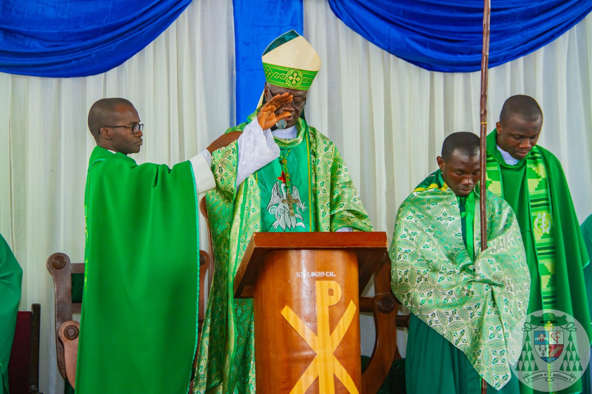 Bishop blessing the congregation during Mass at St Louis Catholic Church